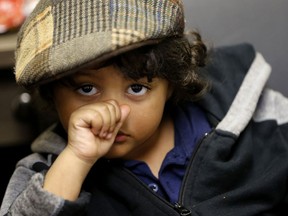 In this Tuesday, Jan. 29, 2019 photo, Elijah Carter, 3, who was taken along with his father into a shelter by Unity Outreach of New Orleans, sits with his father at their offices in New Orleans. After years of a declining homeless population, agencies are "at a virtual standstill" as they struggle to keep up with the number of people newly homeless in the city, according to officials at Unity of Greater New Orleans.