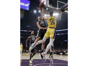 Golden State Warriors' Klay Thompson, left, blocks a shot from Los Angeles Lakers' Moritz Wagner (15) during the first half of an NBA basketball game Thursday, April 4, 2019, in Los Angeles.