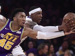 Utah Jazz guard Donovan Mitchell, left, and Los Angeles Lakers guard Kentavious Caldwell-Pope go after a loose ball during the first half of an NBA basketball game Sunday, April 7, 2019, in Los Angeles.