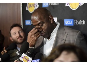 Magic Johnson wipes his eyes as he speaks to reporters prior to an NBA basketball game between the Los Angeles Lakers and the Portland Trail Blazers on Tuesday, April 9, 2019, in Los Angeles. Johnson abruptly quit as the Lakers' president of basketball operations Tuesday night, citing his desire to return to the simpler life he enjoyed as a wealthy businessman and beloved former player before taking charge of the franchise just over two years ago.