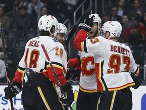 Calgary Flames forward Sam Bennett (93) celebrates his goal with teammates during the first period of an NHL hockey game against Los Angeles Kings, Monday, April 1, 2019, in Los Angeles.