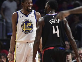 Golden State Warriors forward Kevin Durant, left, and Los Angeles Clippers forward JaMychal Green jaw at each other during the second half in Game 3 of a first-round NBA basketball playoff series Thursday, April 18, 2019, in Los Angeles. The Warriors won 132-105.