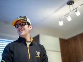 Humboldt Broncos bus crash survivor Layne Matechuk speaks with his father Kevin at their home in Saskatoon, Thursday, March 21, 2019. Matechuk, 19, was one of the 13 survivors of the Humboldt bus crash nearly a year ago that claimed the lives of 16 people. He was in a coma for a month after the accident. He suffered a brain injury that has impacted his ability to speak and has limited the use of his right arm.