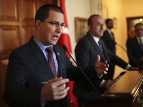FILE - In this Monday, April 1, 2019 file photo, Venezuela's Foreign Minister Jorge Arreaza, left, speaks during a joint news conference with Turkey's Foreign Minister Mevlut Cavusoglu in Ankara, Turkey. Venezuela's foreign minister in the Middle East, said Wednesday in Lebanon that opposition leader Juan Guaidó is in breach of the constitution and that the judiciary has to "take care" of it. Arreaza met with Lebanon's president and foreign minister and is expected to meet with an official from the Hezbollah militant group before traveling onward to Syria. (Turkish Foreign Ministry via AP, Pool, File)