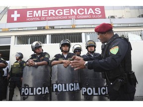Peru's police officers stand guard at the emergency hospital Casimiro Ulloa where former Peruvian President Alan Garcia was taken after he shot himself in his neck, in Lima, Peru, Wednesday, April 17, 2019.   Garcia shot himself before being detained by police.