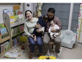 In this March 25, 2019 photo, a South Korean woman Seo Hyo Sun, left, speaks during an interview at her home in Buchon, South Korea. Every baby born in South Korea last year considered to be 2 on Jan. 1. Parents whose babies are born in December often worry about their kids falling behind other children born earlier in the same year, though worries gradually disappear as their children age. When Seo Hyo Sun from Buchon, just west of Seoul, was taken to the hospital to get a cesarean section on Dec. 29, she couldn't stop weeping because her baby's due date was supposed to be Jan. 7.