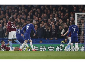 Chelsea's Eden Hazard, third left, scores his sides first goal during the English Premier League soccer match between Chelsea and West Ham at Stamford Bridge stadium in London, Monday, April 8, 2019.