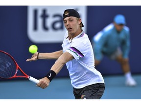 FILE - In this Thursday, March 28, 2019 file photo, Denis Shapovalov, of Canada, hits a backhand to Frances Tiafoe, of the United States, at the Miami Open tennis tournament in Miami Gardens, Fla. Denis Shapovalov's clay-court campaign got off to a poor start as he lost 5-7, 6-3, 6-1 to Jan-Lennard Struff in the first round of the Monte Carlo Masters on Monday, April 15, 2019.