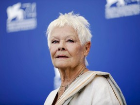 FILE - In this Sunday, Sept. 3, 2017 file photo, actress Judi Dench poses during a photo call for the film "Victoria And Abdul" at the 74th Venice Film Festival in Venice, Italy. Judi Dench is back in the world of espionage _ but her latest role is a far cry from James Bond's unflappable spy chief, M. In "Red Joan," released in Britain and the U.S. on Friday, April 19, 2019, Dench plays an elderly British woman whose quiet suburban life is upended when police come knocking, accusing her of passing nuclear secrets to the Soviet Union during the Cold War.