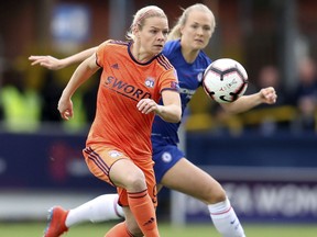 Lyon's Eugenie Le Sommer, front, in action with Chelsea's Magdalene Ericsson during the UEFA Women's Champions League semi final second leg soccer match at the Cherry Red Records Stadium, London, Sunday, April 28, 2019.