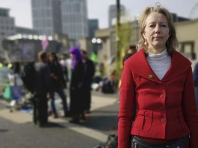 Co-founder of Extinction Rebellion Dr Gail Bradbrook poses for the media on Waterloo Bridge, in London, Thursday, April 18, 2019, as she says protests will escalate if its demands are not met. Climate change protesters glued themselves to a train and blocked major London intersections Wednesday, on the third day of a civil disobedience campaign. Three demonstrators were arrested after stopping Docklands Light Railway services at Canary Wharf station. Several others glued themselves together outside the house of opposition Labour Party leader Jeremy Corbyn.