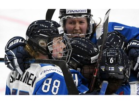 Goal scorer Finland's Ronja Savolainen, left, celebrates after scoring with teammates Rosa Lindstedt, Noora Tulus and Jenni Hiirikoski during the IIHF Women's Ice Hockey World Championships semifinal match between Canada and Finland in Espoo, Finland, Saturday, April 13, 2019.