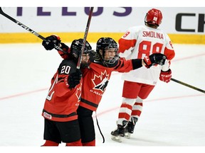 Sarah Nurse, left, and goal scorer Natalie Spooner of Canada celebrate the game opening goal during the IIHF Women's Ice Hockey World Championships Group A match between Canada and Russia in Espoo, Finland, Monday, April 8, 2019.