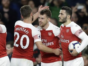 Arsenal's Aaron Ramsey, center, celebrates scores his side's first goal during the English Premier League soccer match between Arsenal and Newcastle United at Emirates stadium in London, Monday, April 1, 2019.