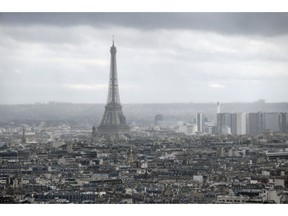 FILE - This Tuesday, March 27, 2018 file photo shows the Eiffel Tower from the Paris new courthouse, in Paris. Monuments are the emotional backbone of France. That accounts for the despair over a blaze that killed no one, yet seared the collective soul. It is the power Notre Dame had _ still has, despite the charred scars on its Gothic walls.