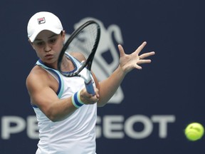 FILE - In this file photo dated Saturday, March 30, 2019, Ashleigh Barty of Australia, returns to Carolina Pliskova of the Czech Republic, during the singles final of the Miami Open tennis tournament, in Miami Gardens, Fla.   Barty beat doubles partner Victoria Azarenka of Belarus 7-6 (2), 6-3 to level their Fed Cup semifinal at 1-1, at Pat Rafter Arena, Australia, on Saturday April 20, 2019.