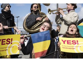 FILE - In this Tuesday March 26, 2019 file photo, people gather at the front of the European Parliament building in Strasbourg, France, to show their support for the copyright bill. The European Union approved on Monday April 15, 2019, a copyright law that aims to give more protection to artists and news organizations but which critics say will stifle freedom of speech and online creativity and punish smaller web companies.