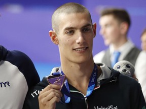 FILE - In this file photo dated Thursday, Aug. 9, 2018 bronze medalist Andrea Vergani of Italy poses on the podium of the 50 meters freestyle men final at the European Swimming Championships in Glasgow, Scotland. The Italian swimmer who posted the world's best time in the men's 50-meter freestyle this year has been provisionally suspended after testing positive for cannabis.