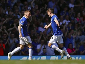 Everton's Lucas Digne, left, celebrates scoring against Manchester United with teammate Seamus Coleman during the English Premier League soccer match at Goodison Park, Liverpool, England, Sunday April 21, 2019.