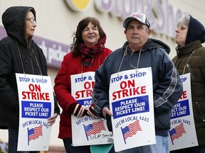 Striking workers stand on a picket line outside the Stop & Shop supermarket in Revere, Mass., Thursday, April 18, 2019. Some Jewish families in southern New England are preparing for Passover without the region's largest supermarket chain. Thousands of workers remain on strike and rabbis in Massachusetts, Connecticut and Rhode Island are advising their congregations not to cross the picket lines.