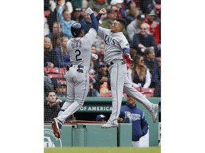 Tampa Bay Rays' Yandy Diaz (2) celebrates his solo home run with teammate Willy Adames during the first inning of a baseball game against the Boston Red Sox in Boston, Saturday, April 27, 2019.