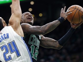Boston Celtics' Terry Rozier (12) shoots against Orlando Magic's Khem Birch (24) during the first half of an NBA basketball game in Boston, Sunday, April 7, 2019.