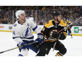 Boston Bruins' Jeremy Lauzon (79) defends against Tampa Bay Lightning's Ryan Callahan (24) during the first period of an NHL hockey game in Boston, Saturday, April 6, 2019.