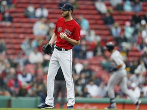 Boston Red Sox's Chris Sale stands on the mound after giving up a solo home run to Detroit Tigers' Grayson Greiner, right, during the fifth inning in the first game of a baseball doubleheader in Boston, Tuesday, April 23, 2019.