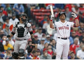 Boston Red Sox's Steve Pearce, right, reacts beside Baltimore Orioles catcher Jesus Sucre after being called out on a check-swing third strike during the second inning of a baseball game in Boston, Monday, April 15, 2019.