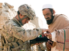 U.S. Army Pfc. Mark Domingo takes an Afghan man’s fingerprints in the village of Dande Fariqan, Nov. 5, 2012. Domingo has been charged for a thwarted alleged terror plot.