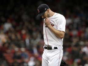 Boston Red Sox pitcher Chris Sale wipes his face on his jersey as he steps off the mound after throwing in the fourth inning of a baseball game against the Tampa Bay Rays at Fenway Park, Sunday, April 28, 2019, in Boston.