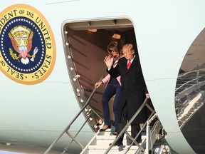 President Donald Trump and first lady Melania Trump disembark Air Force One upon arrival at Andrews Air Force Base, Md., Sunday, March 31, 2019.