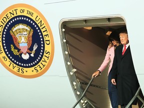 President Donald Trump and first lady Melania Trump get off from Air Force One upon arrival at Andrews Air Force Base, Md., Sunday, March 31, 2019.