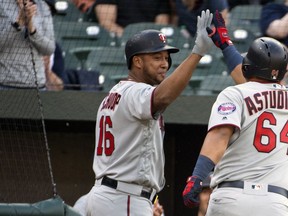 Minnesota Twins' Willians Astudillo (64) celebrates with Jonathan Schoop (16) in the second inning of a baseball game against the Baltimore Orioles, Saturday, April 20, 2019, in Baltimore.