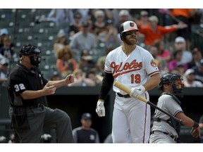 Baltimore Orioles first baseman Chris Davis (19) reacts after striking out in the seventh inning of a baseball game against the New York Yankees, Sunday, April 7, 2019, in Baltimore.