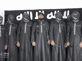 This undated image posted by the Islamic State group's Aamaq news agency on April 23, 2019, purports to show Mohammed Cassim Zaharan, also known as Zaharan Hashmi, centre, the man Sri Lanka says led the Easter attack that killed over 350 people, as well as other attackers.