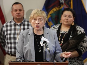 Maine Gov. Janet Mills speaks at the signing ceremony to establish Indigenous Peoples' Day, Friday, April 26, 2019, at the State House in Augusta, Maine. Mills added Maine to the growing number of states who have passed similar legislation. William J. Nicholas Sr., Governor of the Passamaquoddy Tribe-Indian Township, left, and Clarissa Sabattus, Tribal Chief of Houlton Band of Maliseet Indians attend the event.