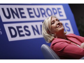 Far-right leader of the National Rally party Marine Le Pen, smiles as she attends a media conference for the upcoming European elections next month in Strasbourg, eastern France, Monday, April 15, 2019. Background reads, a Europe of Nations.