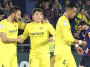 Barcelona forward Lionel Messi, right, reacts after Villarreal scored their fourth goal during the Spanish La Liga soccer match between Villarreal and FC Barcelona at the Ceramica stadium in Villarreal, Spain, Tuesday, April 2, 2019.