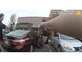 In this frame grab from a Charlotte-Mecklenburg Police Department officer body camera released Monday, April 15, 2019, shows two officers approaching 27-year-old Danquirs Napoleon Franklin outside a Burger King on March 29, 2019 in Charlotte, NC. Franklin was shot and killed. (Charlotte-Mecklenburg Police Department via AP)