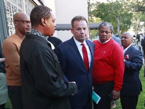 FILE- In this Jan. 11, 2019 file photos suspended Broward County Sheriff Scott Israel, center, leaves a news conference surrounded by supporters after new Florida Gov. Ron DeSantis suspended him, in Fort Lauderdale, Fla. The Florida Supreme Court has ruled against a sheriff who fought his removal from office after the governor claimed he failed to prevent last year's Parkland school shooting. Florida's highest court agreed Tuesday, April 23, 2019, that Gov. Ron DeSantis was within his authority to suspend Israel as Broward County sheriff earlier this year. The justices noted that under the Florida Constitution, the state Senate is responsible for deciding whether the removal should be permanent.