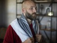 Michael Behenna wears a scarf he brought home from Iraq at his farm near Guthrie, Okla., where he has been living since his parole from military prison.
