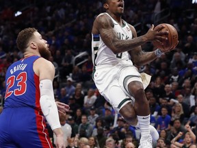 Milwaukee Bucks guard Eric Bledsoe, right, makes a layup as Detroit Pistons forward Blake Griffin (23) watches during the first half of Game 3 of a first-round NBA basketball playoff series, Saturday, April 20, 2019, in Detroit.