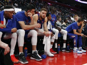 Detroit Pistons forward Blake Griffin, third from left, sits on the bench after fouling out during the second half of Game 4 of a first-round NBA basketball playoff series against the Milwaukee Bucks, Monday, April 22, 2019, in Detroit.