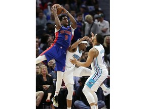 Detroit Pistons guard Langston Galloway (9) grabs a rebound over Charlotte Hornets guard Malik Monk, center, and forward Miles Bridges, right, during the second half of an NBA basketball game Sunday, April 7, 2019, in Detroit.