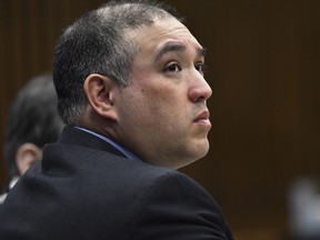 FILE--In this April 10, 2019, file photo, former Michigan state trooper Mark Bessner listens to Assistant Wayne County Prosecutor Matthew Penney deliver his opening argument in Bessner's trial, in Detroit. Charged with second-degree murder, Bessner was convicted of involuntary manslaughter Wednesday, April 17, 2019, in the death of Detroit teenager, Damon Grimes, who crashed an all-terrain vehicle and died when he was shot with a Taser by Bessner in 2017.