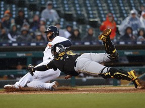 Detroit Tigers' Miguel Cabrera slides safely into home plate ahead of the tag of a diving Pittsburgh Pirates catcher Francisco Cervelli on a Ronny Rodriguez sacrifice fly in the fourth inning of a baseball game in Detroit, Wednesday, April 17, 2019.