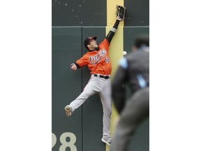 Baltimore Orioles' Trey Mancini tries but fails in his attempt to catch a foul ball off the bat of Minnesota Twins' Jorge Polanco in the third inning of a baseball game Saturday, April 27, 2019, in Minneapolis.