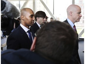 Former Minneapolis police officer Mohamed Noor, center, is accompanied by his attorneys Peter Wold, not pictured, and Thomas Plunkett, right, as he walks towards the Hennepin County Government Center for opening arguments of his trial Tuesday, April 9, 2019, in Minneapolis, Minn. Opening arguments scheduled to begin in the trial of former Minneapolis police officer Mohamed Noor in the shooting death of Justine Ruszczyk Damond.