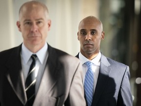 Former Minneapolis police officer Mohamed Noor walks through the skyway with his attorney Thomas Plunkett, left, on the way to court in Minneapolis on Friday, April 26, 2019.